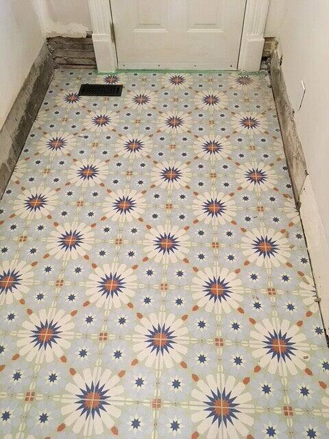 Blue and orange star pattern floor tile in a small entry room